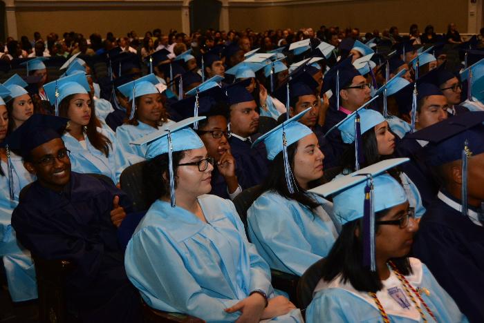 The class of 2015 graduation in light blue and dark blue gowns assigned by gender.