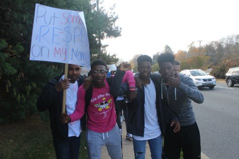 Vinod Swaminathan, Danial Orebiyi, Jafari Daniel, and Bobby Lassiter march together as friends.