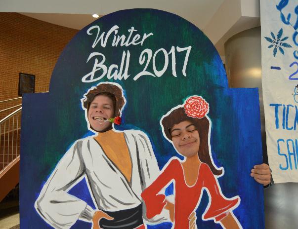 Billy Madden and Jesse Turcious pose in front of the Winter Formal ticket booth.