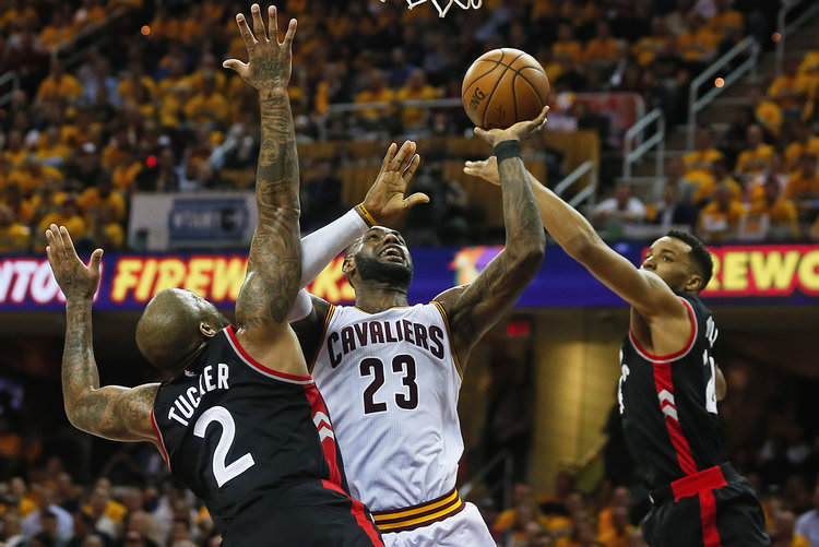 Cleveland Cavaliers forward LeBron James puts the ball up between Toronto Raptors forward PJ Tucker and guard Norman Powell during the fourth quarter in Game 1 of an Eastern Conference playoff game on Monday, May 1, 2017, at Quicken Loans Arena in Cleveland, Ohio. The Cavaliers beat the Raptors 116-105. (Leah Klafczynski/Akron Beacon Journal/TNS)