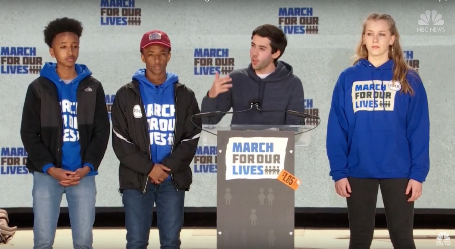 (left to right) Nate Tinbite, Michael Solomon, Matthew Post, and Brenna Levitan, stand on stage at the March For Our Lives. 