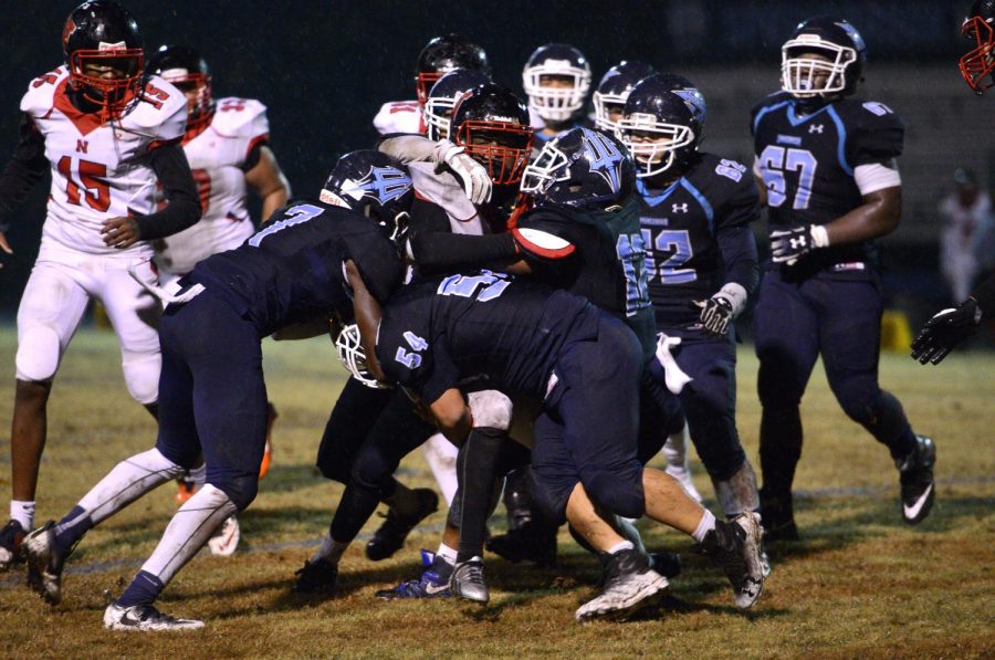 Springbrook Varsity football team clashes with the Northwood Gladiators' line. 