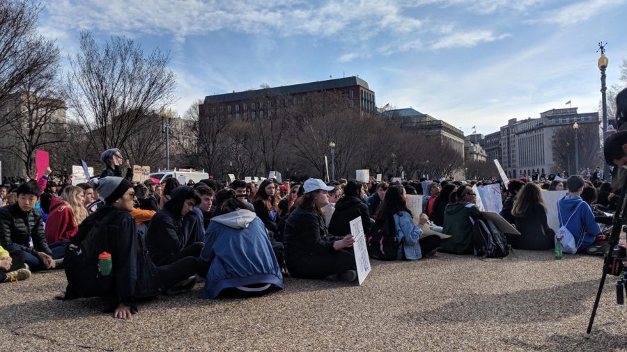 Students sit in silence, commemorating the victims of the Parkland massacre.