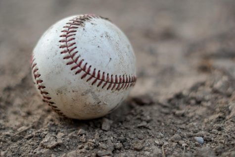 A baseball in the dirt.