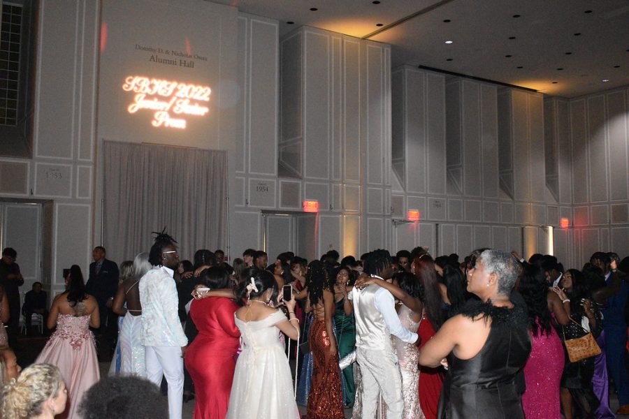 Students dancing and conversing on the dance floor. 